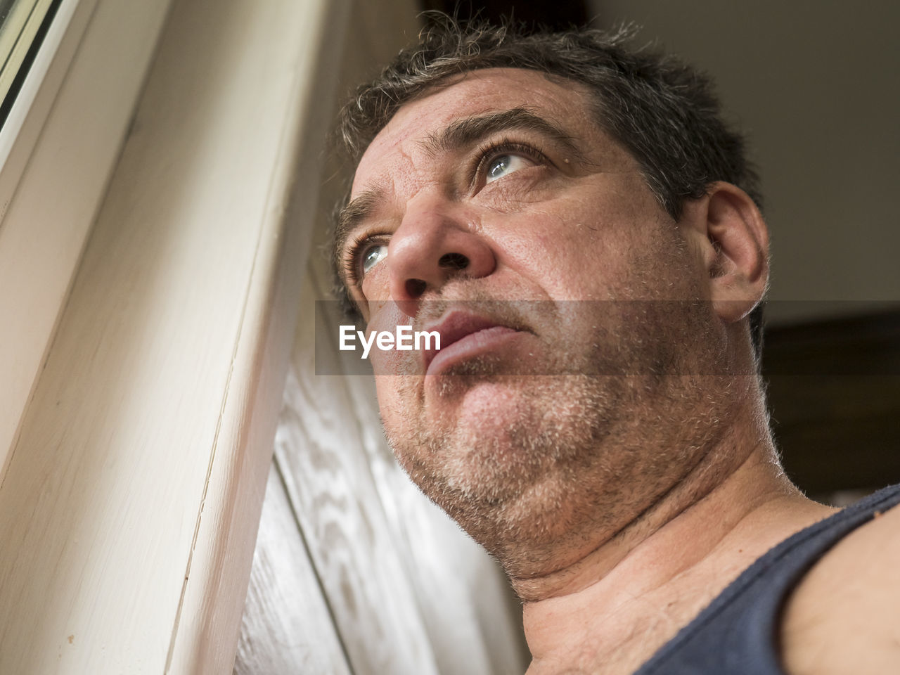 Low angle view of man looking away at home