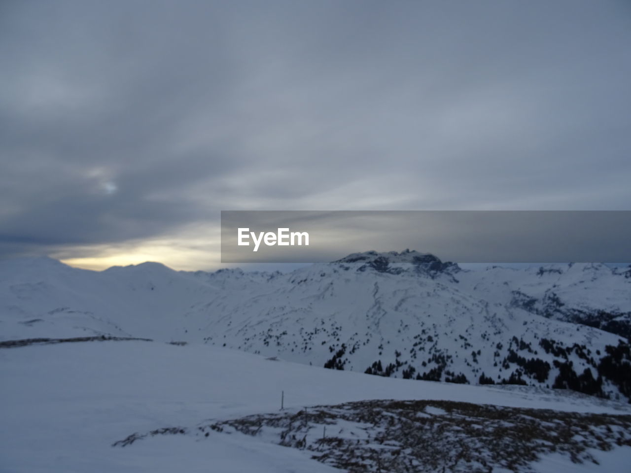 SNOW COVERED MOUNTAINS AGAINST SKY