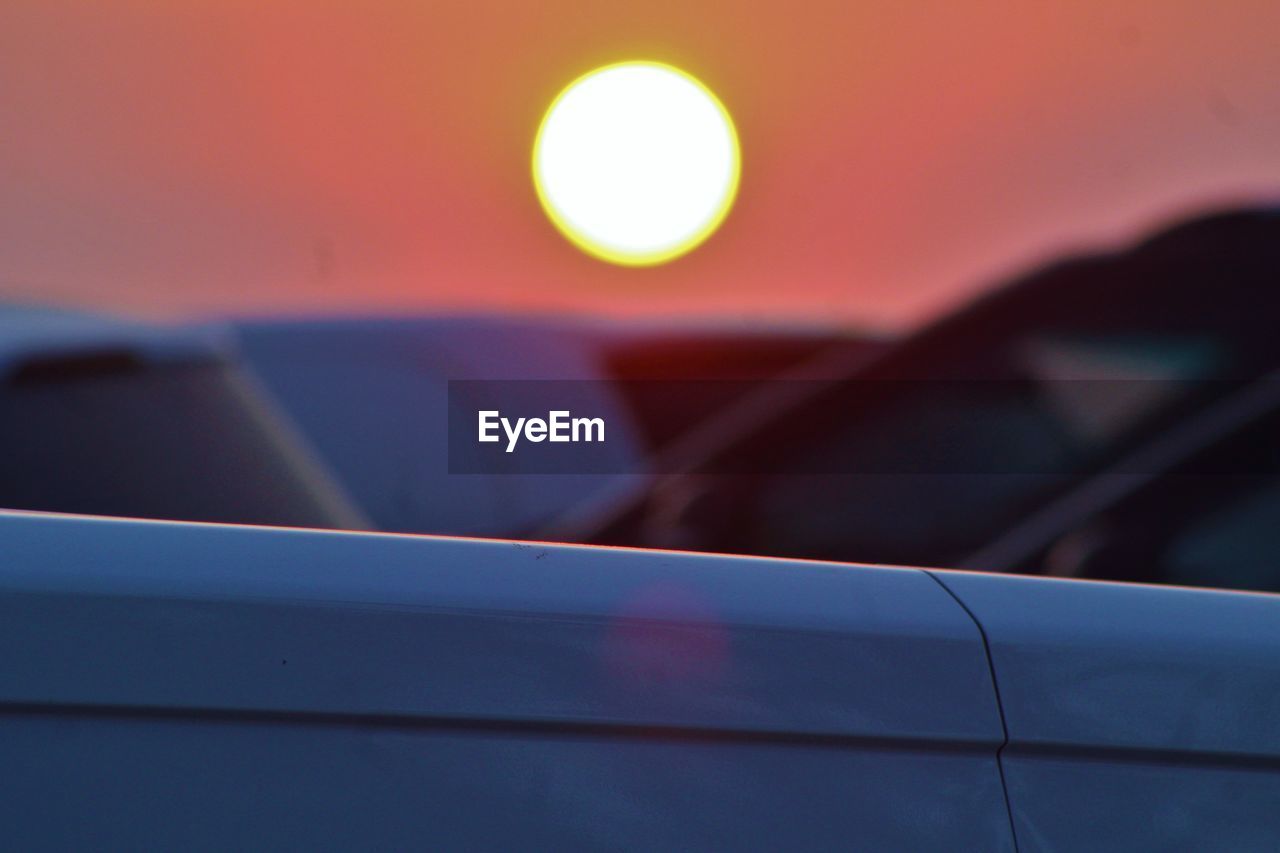 CLOSE-UP OF CAR AGAINST SKY AT NIGHT