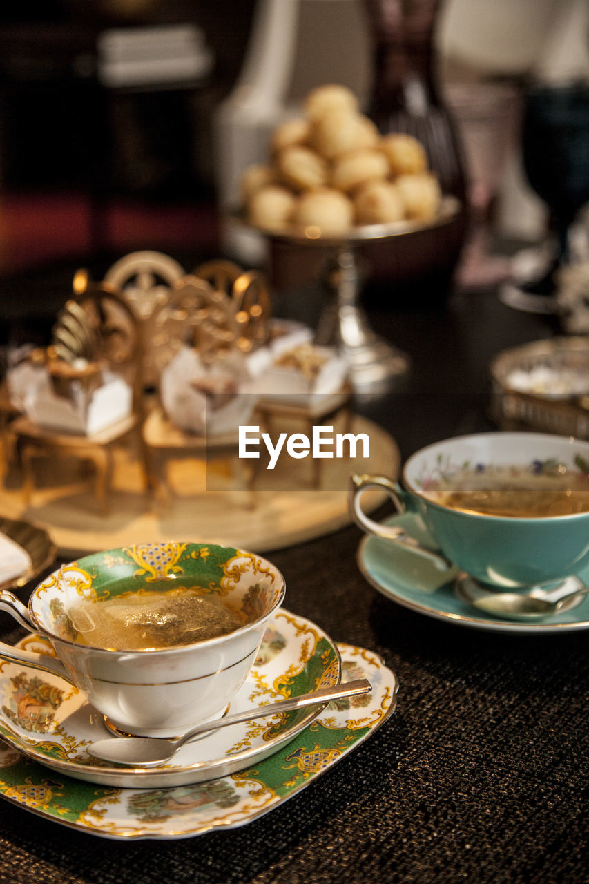 CLOSE-UP OF COFFEE CUP AND SAUCER ON TABLE