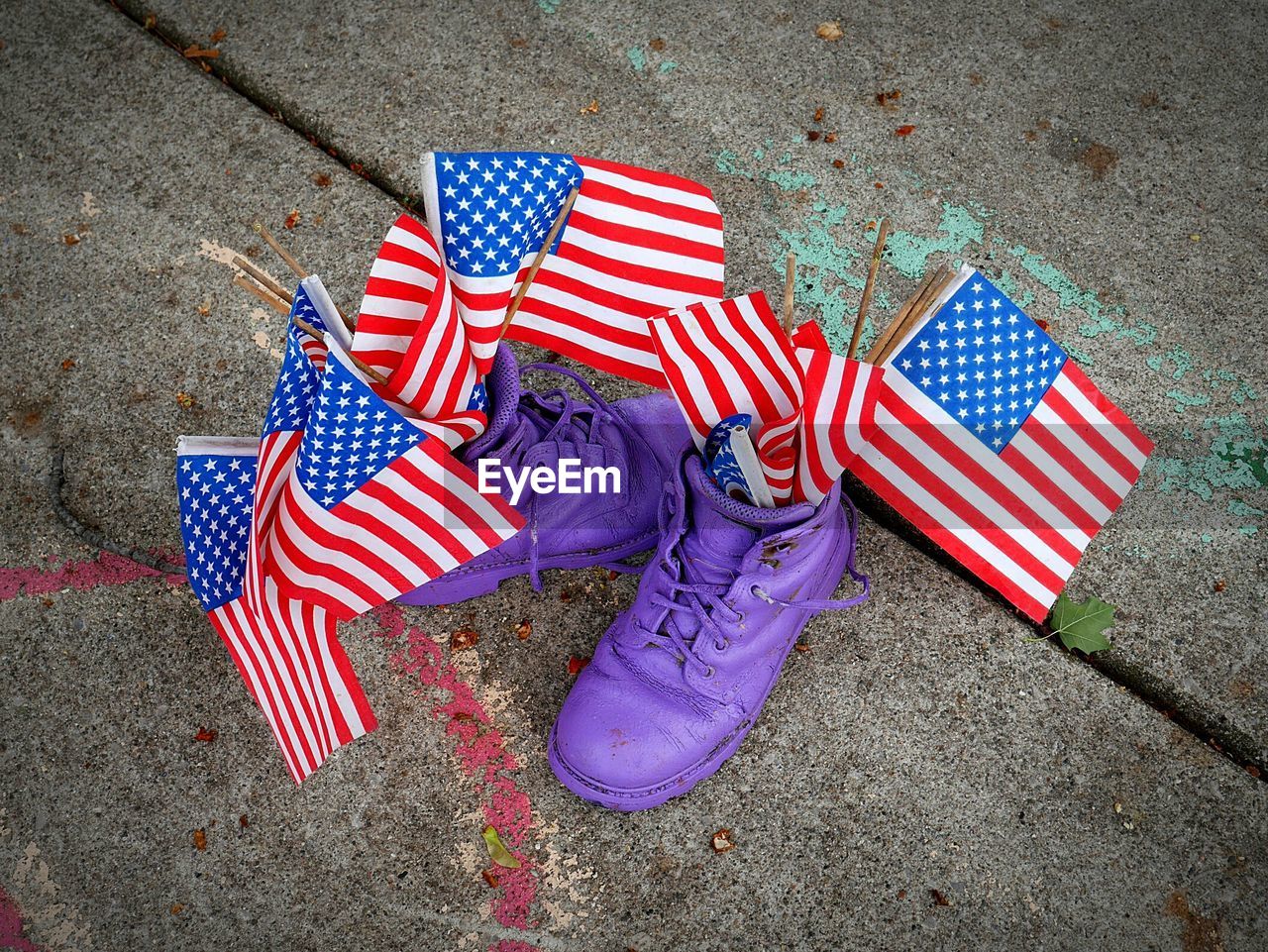 High angle view of american flags in purple shoes on footpath