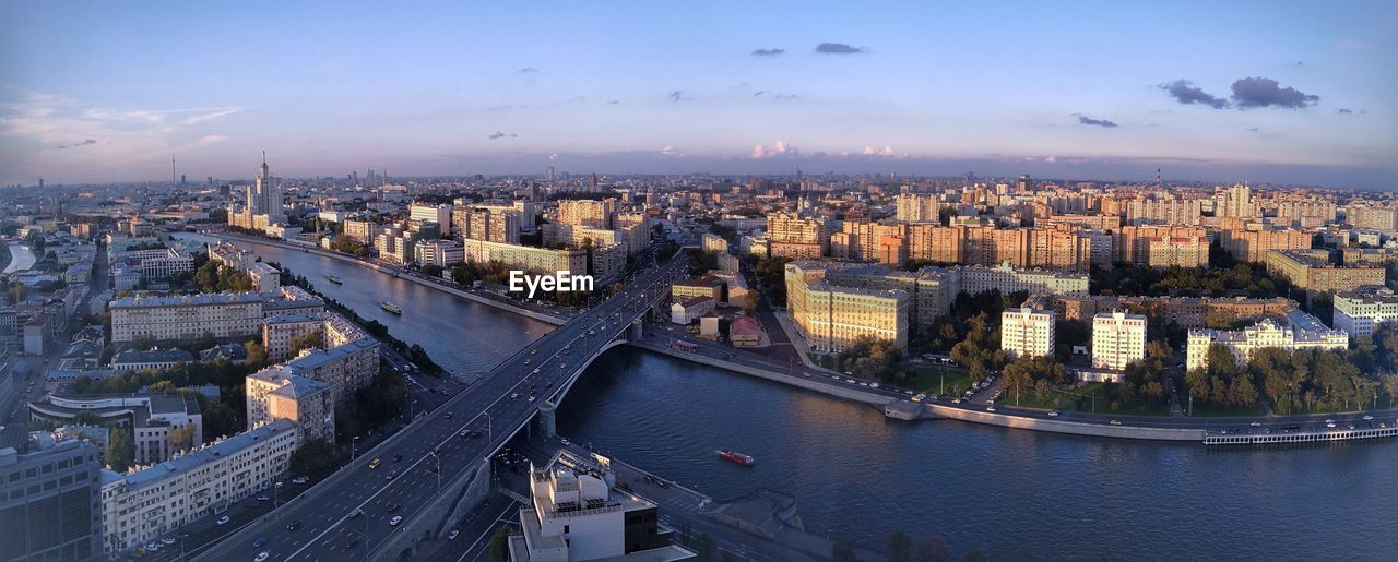 High angle view of bridge over river against sky in city