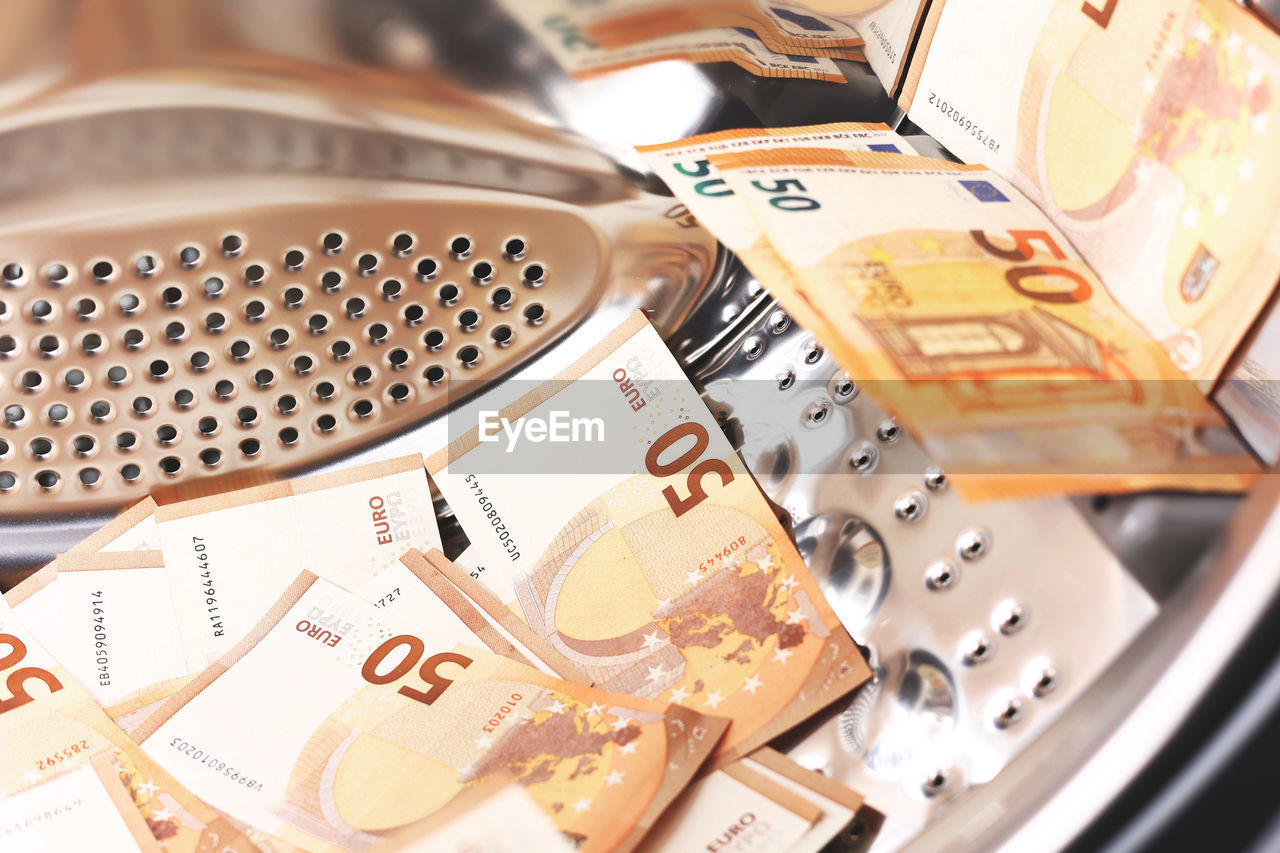 Money laundering symbol, 50 euro banknotes inside washing machine. tax evasion. illegal financial 