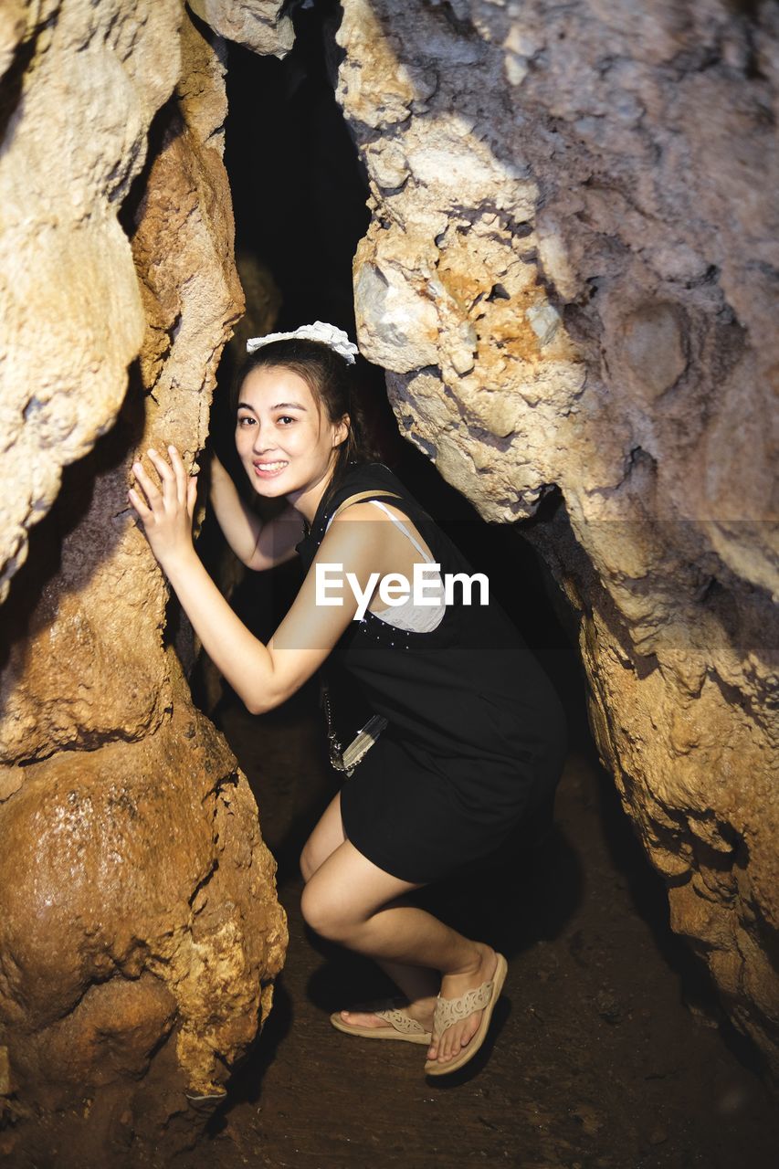 Cave girl in between cave hole