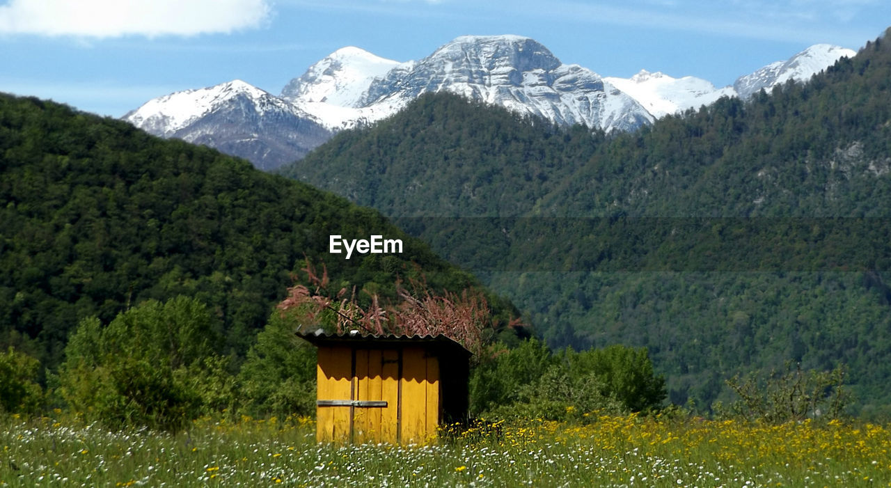 Scenic view of mountains against cloudy sky