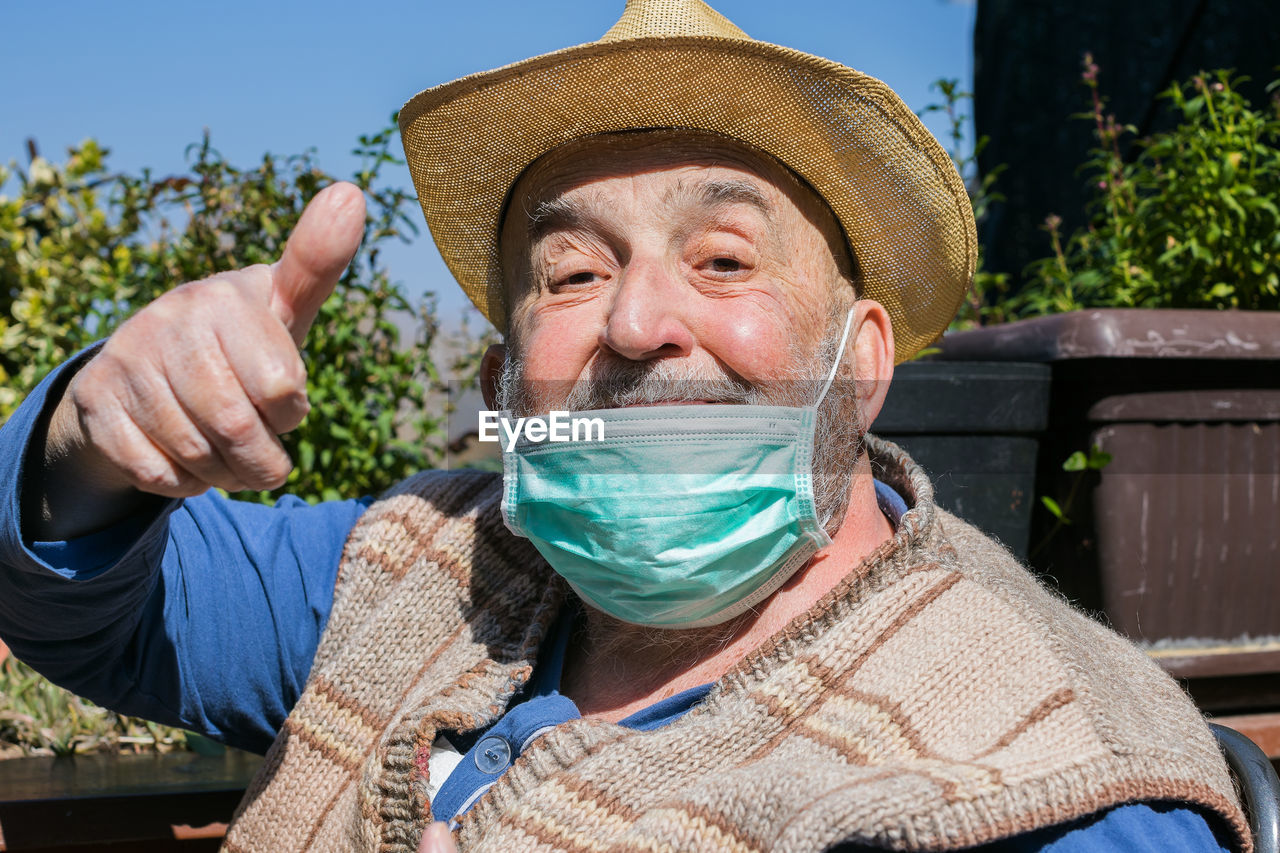 Portrait of man holding hat