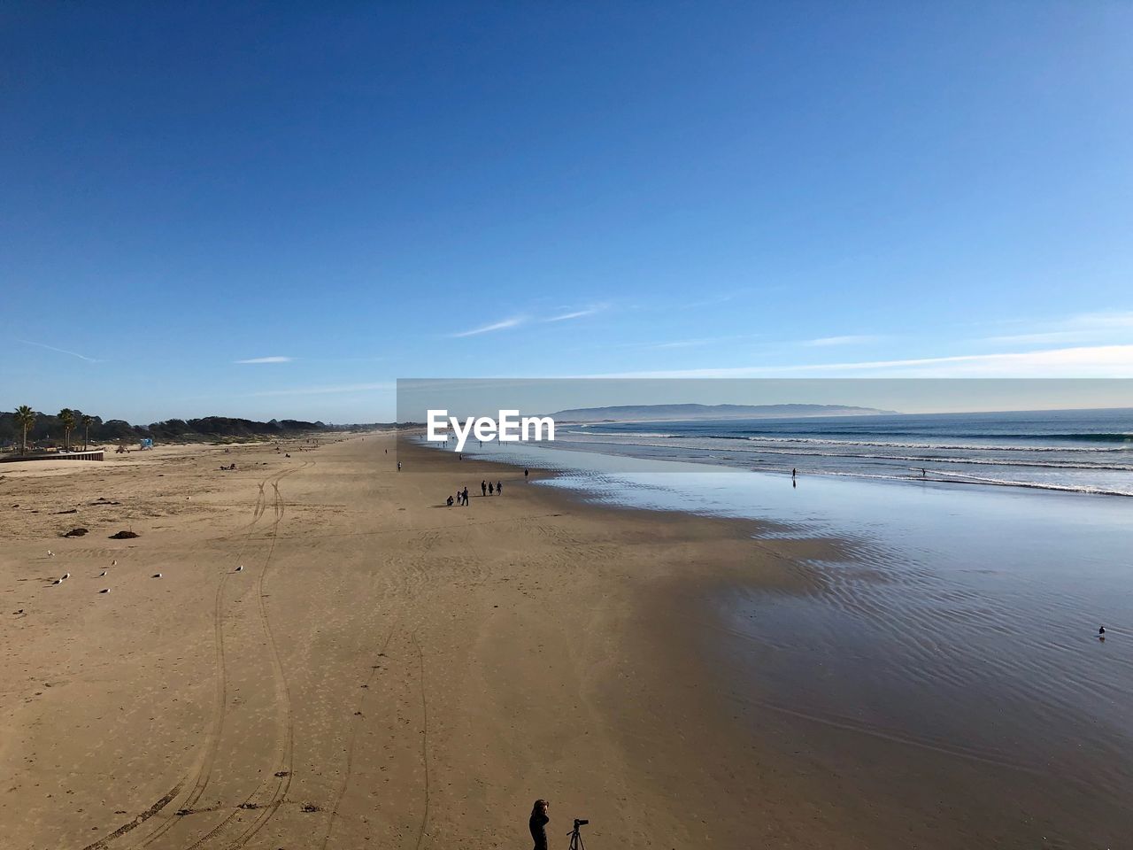 Scenic view of beach against blue sky