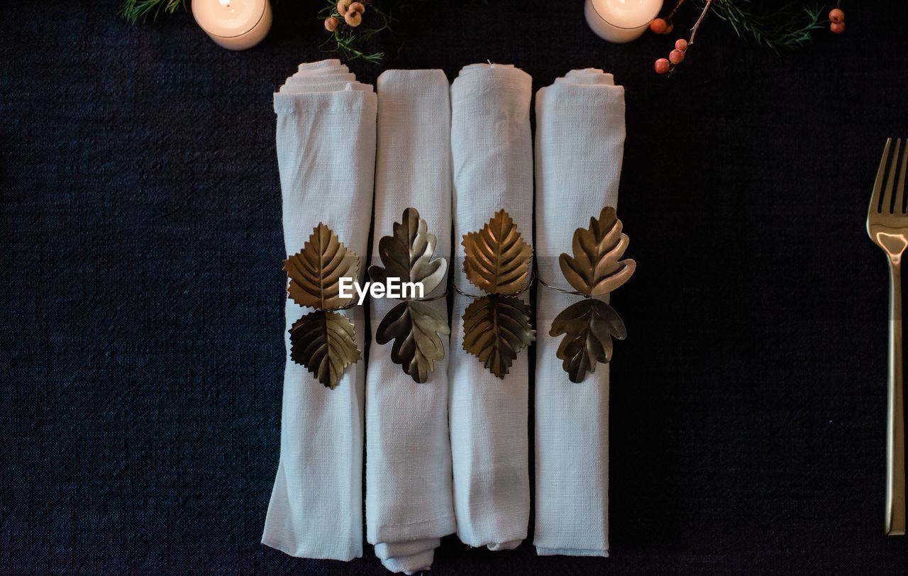 Row of gold and white napkins on a decorated dinner table setting