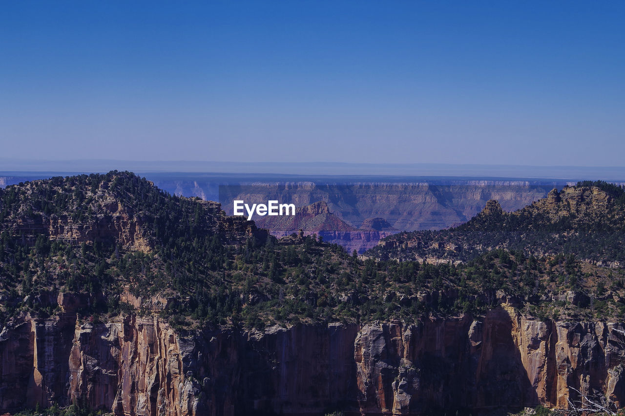 Panoramic view of trees and mountains against clear sky