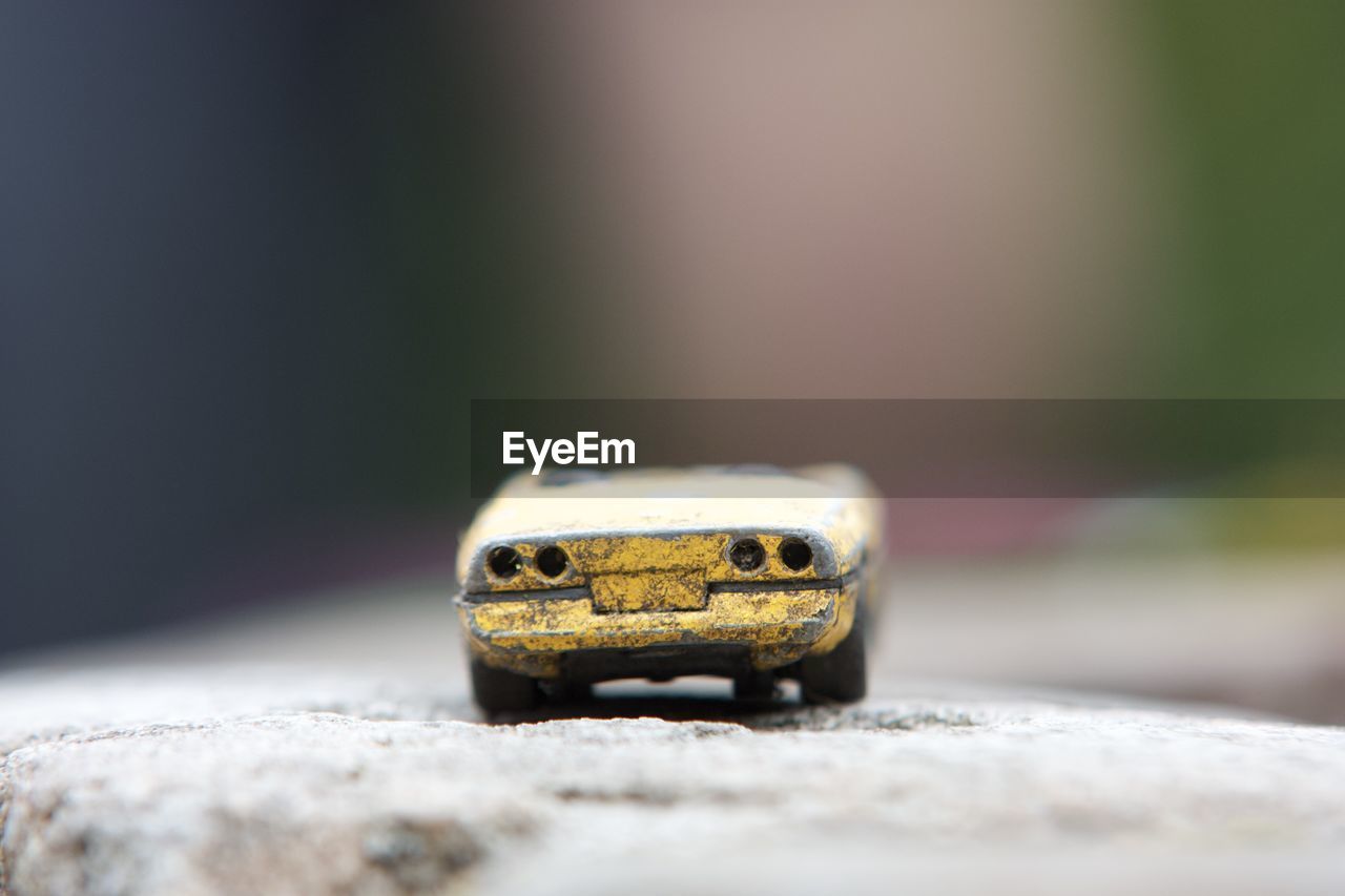 Close-up of a toy car on rock