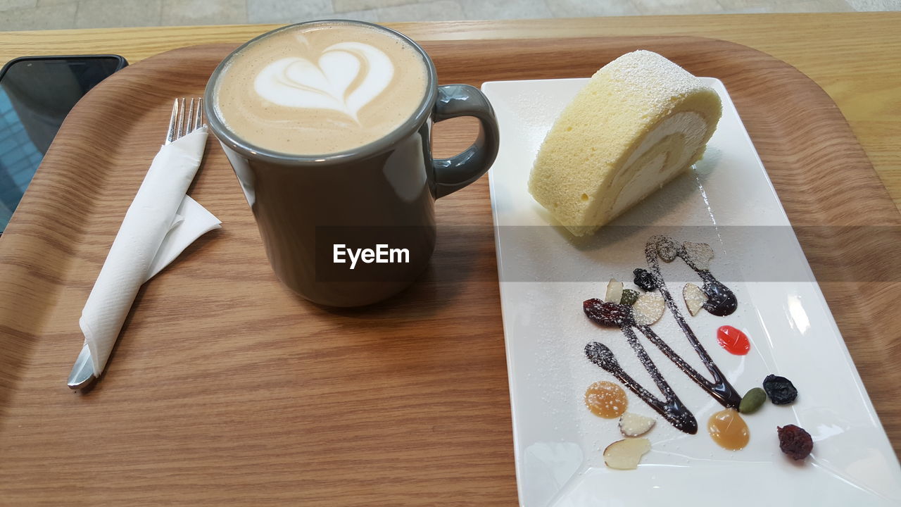 HIGH ANGLE VIEW OF COFFEE CUP ON PLATE