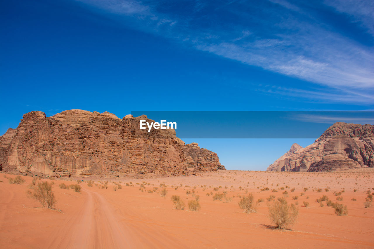 Rock formations in desert against blue sky