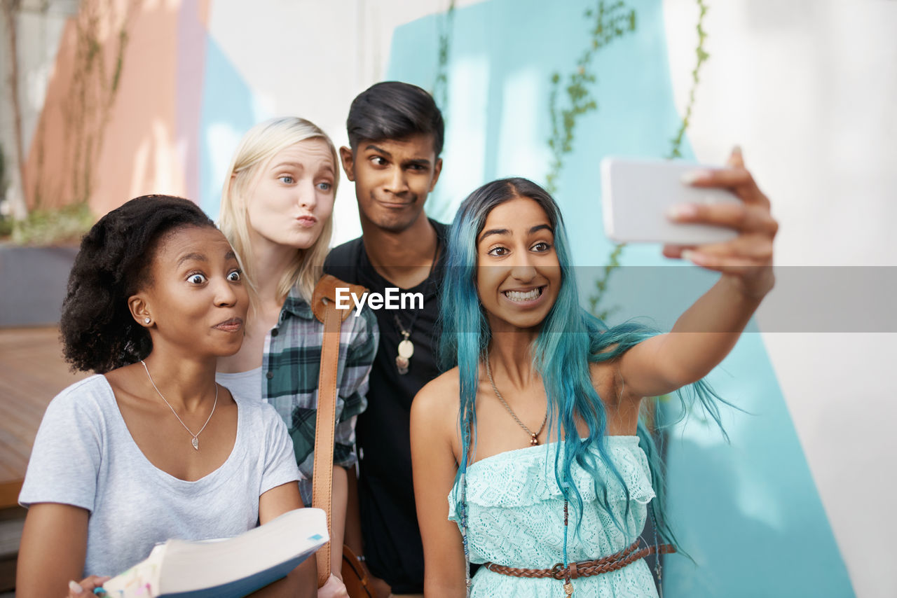 Cheerful friends taking selfie