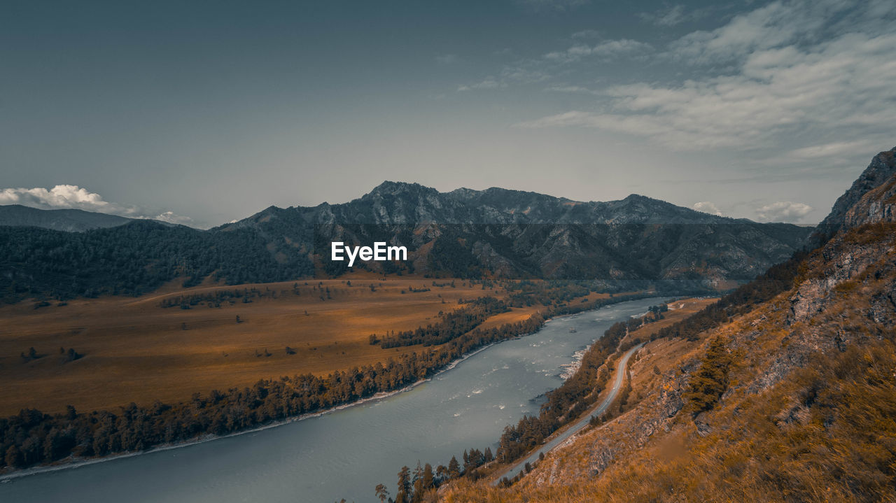 Scenic view of river passing amidst mountains