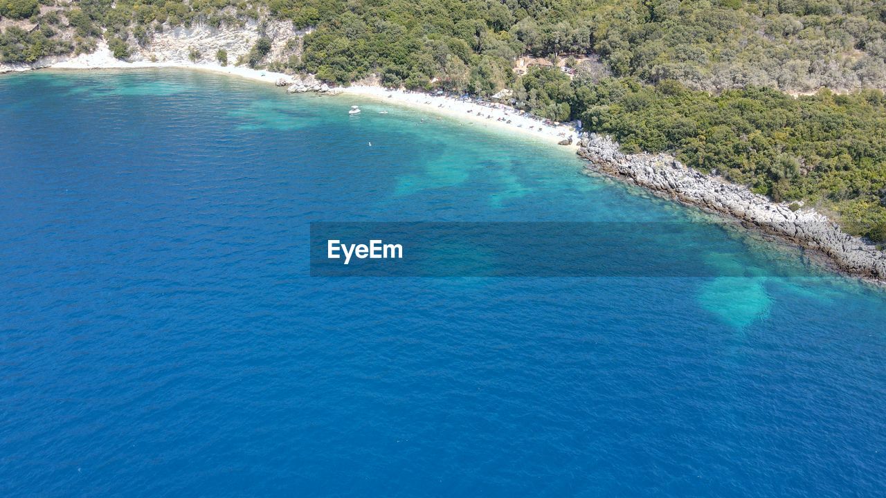 HIGH ANGLE VIEW OF BAY ALONG CALM SEA