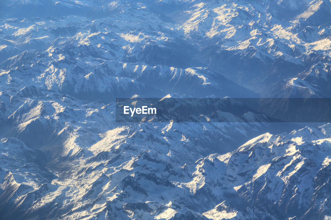 HIGH ANGLE VIEW OF SNOWCAPPED MOUNTAIN AGAINST SKY