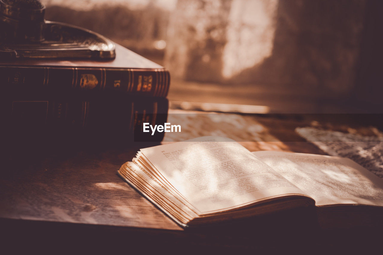 wood, table, publication, book, black, light, no people, darkness, indoors, focus on foreground, sunlight, still life, close-up, white, nature