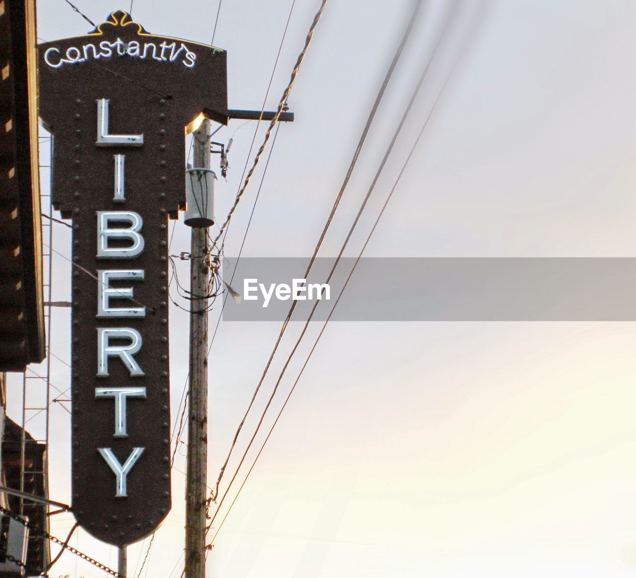 Low angle view of sign board against sky