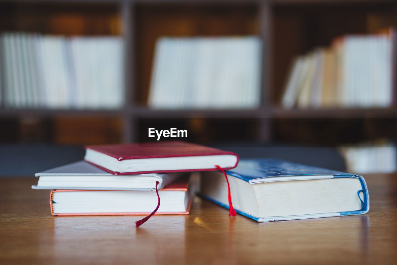 Close-up of books on wooden table at library