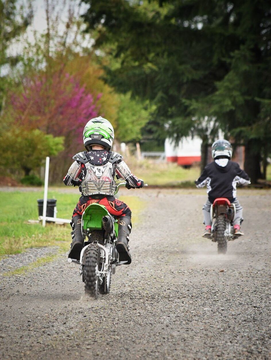 PEOPLE RIDING MOTORCYCLE ON CART