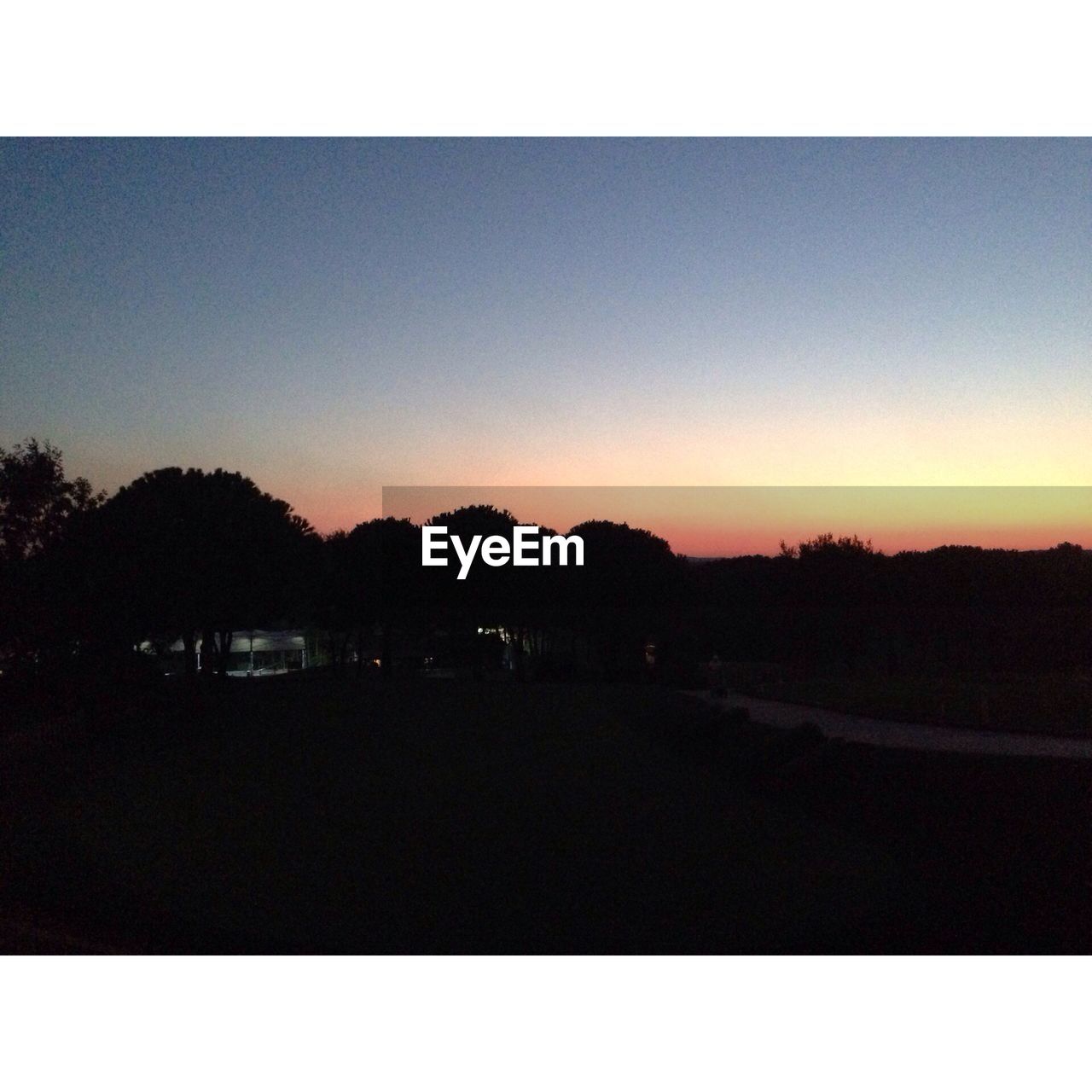 Scenic view of silhouette field against sky during sunset