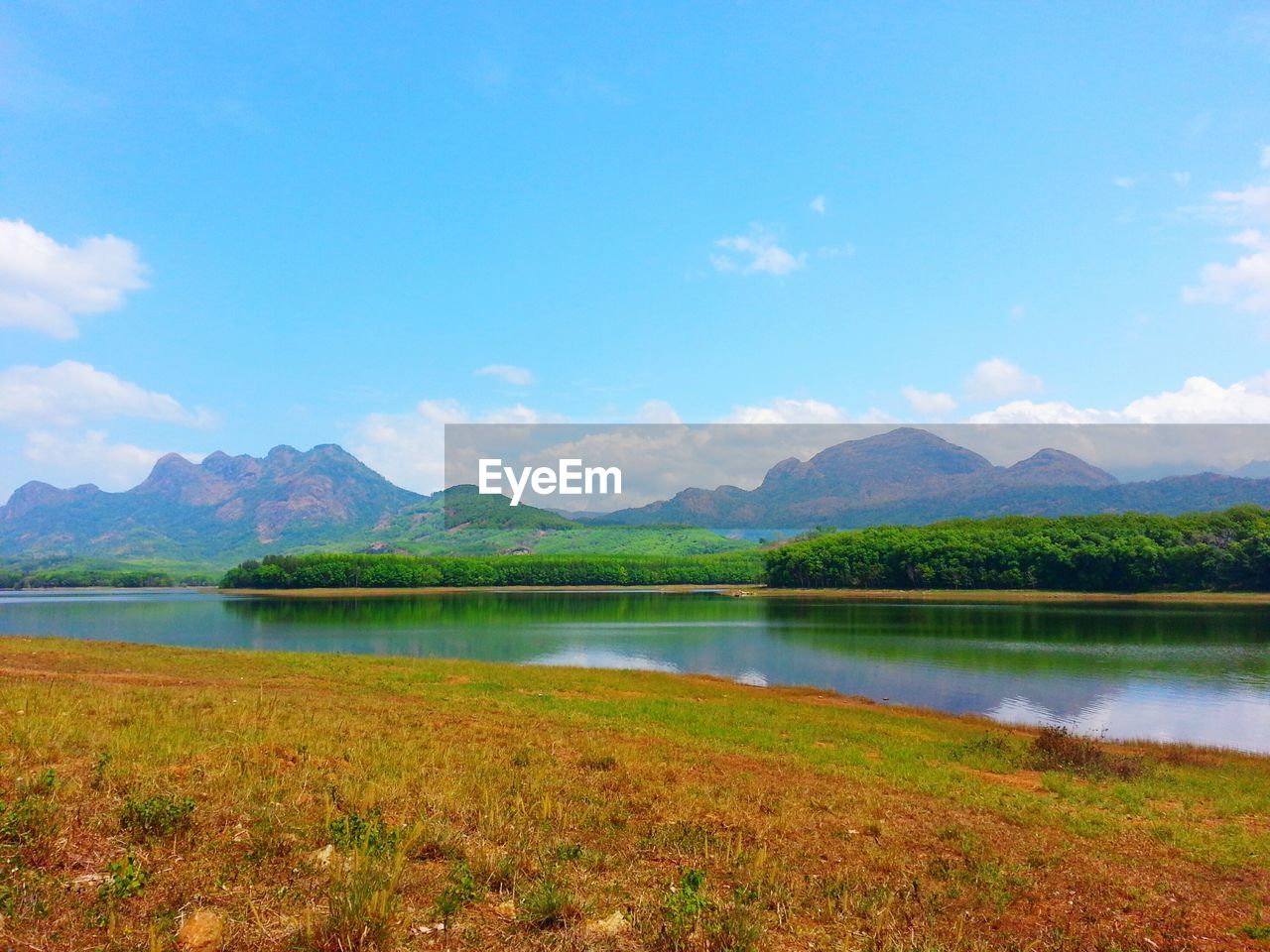 Scenic view of lake against blue sky