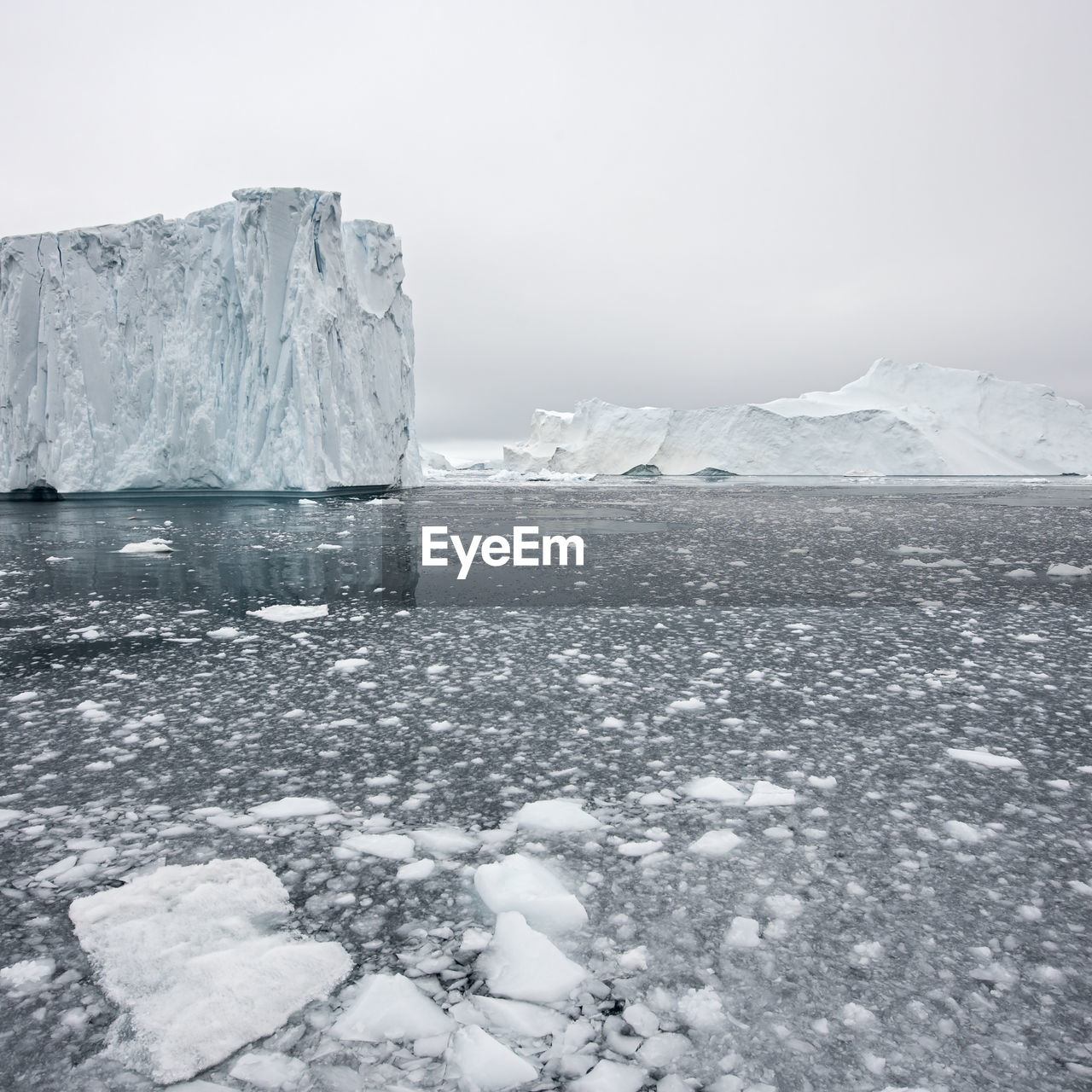 Glacier on sea against clear sky