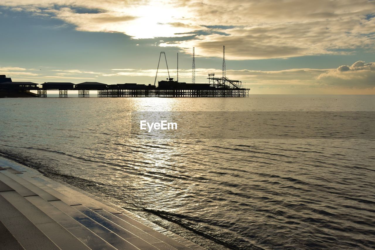Scenic view of sea  and pier against sky during sunset