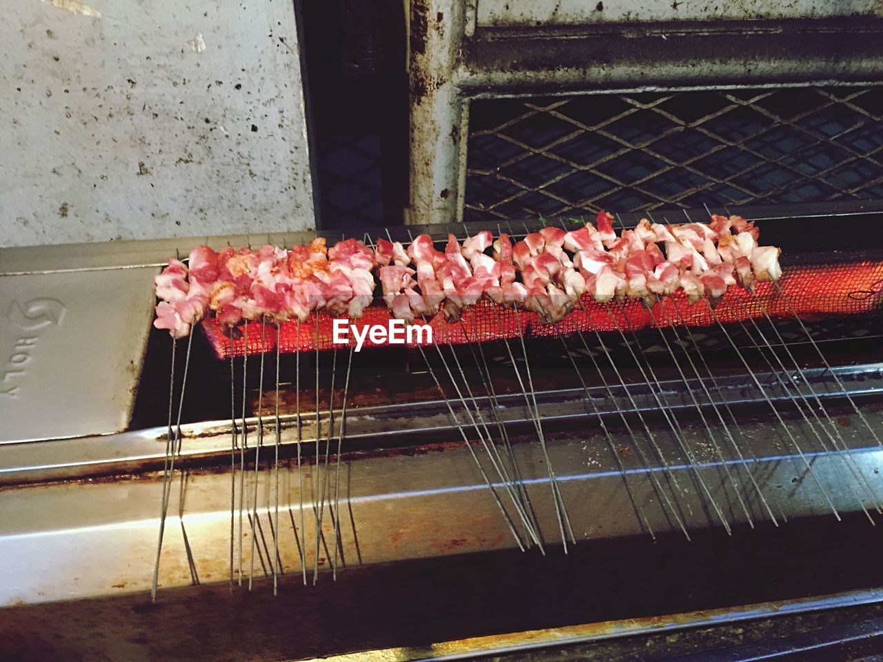 High angle view of food with skewers on barbecue