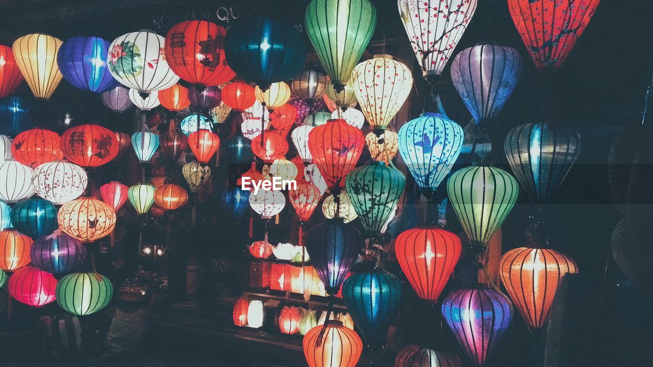 Colorful lanterns hanging for sale at night