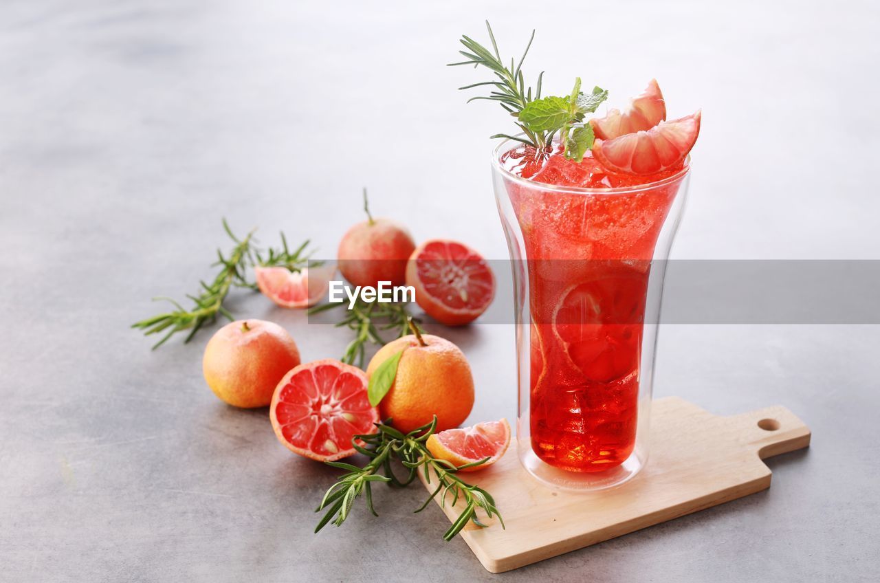 CLOSE-UP OF FRUITS WITH GLASS OF JUICE