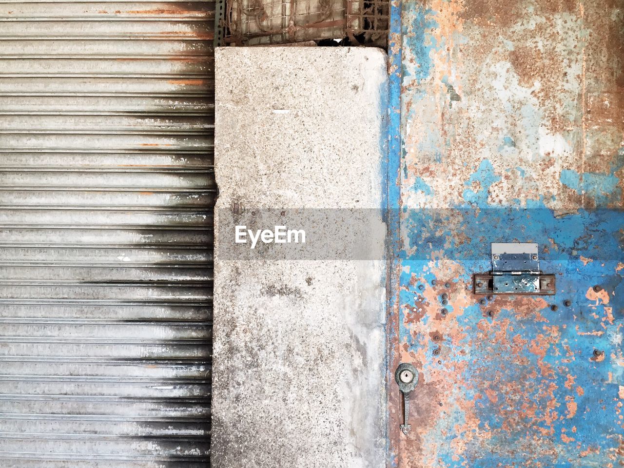 Rusty weathered door by closed store