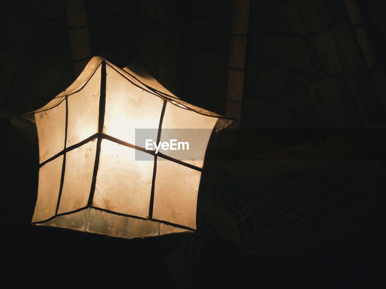 Close-up of illuminated lantern at home