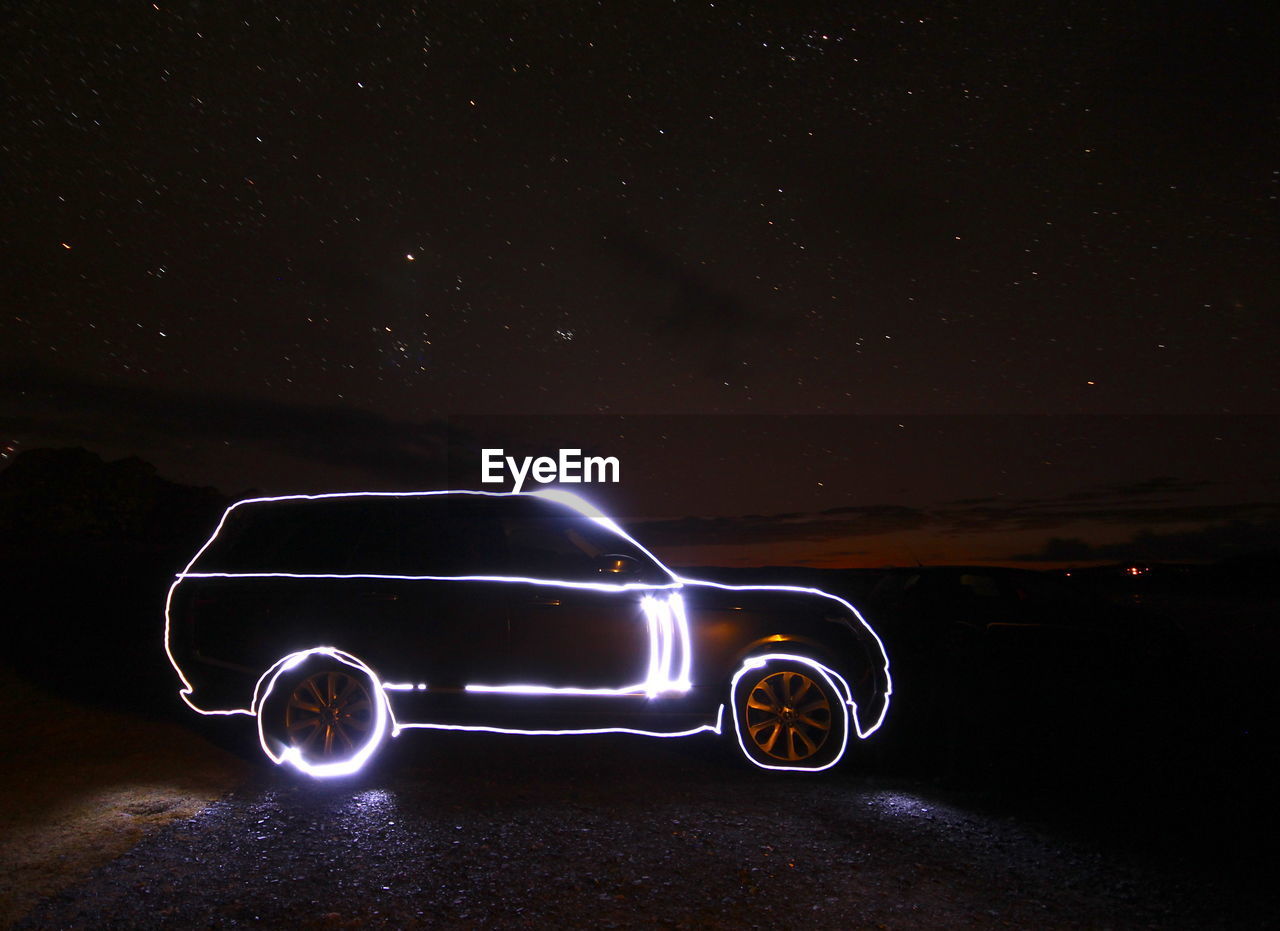 ILLUMINATED CAR AGAINST SKY