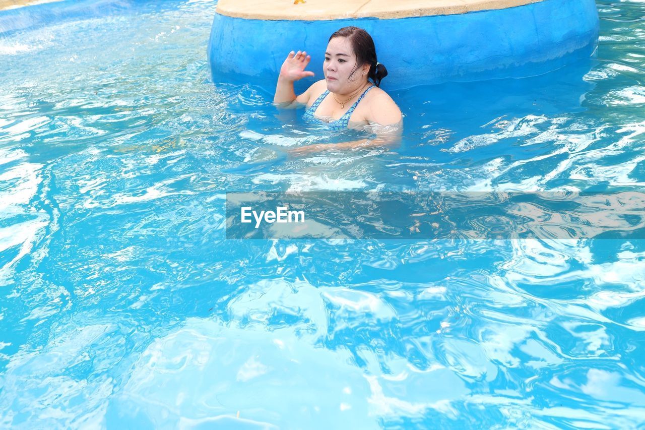 WOMAN IN SWIMMING POOL