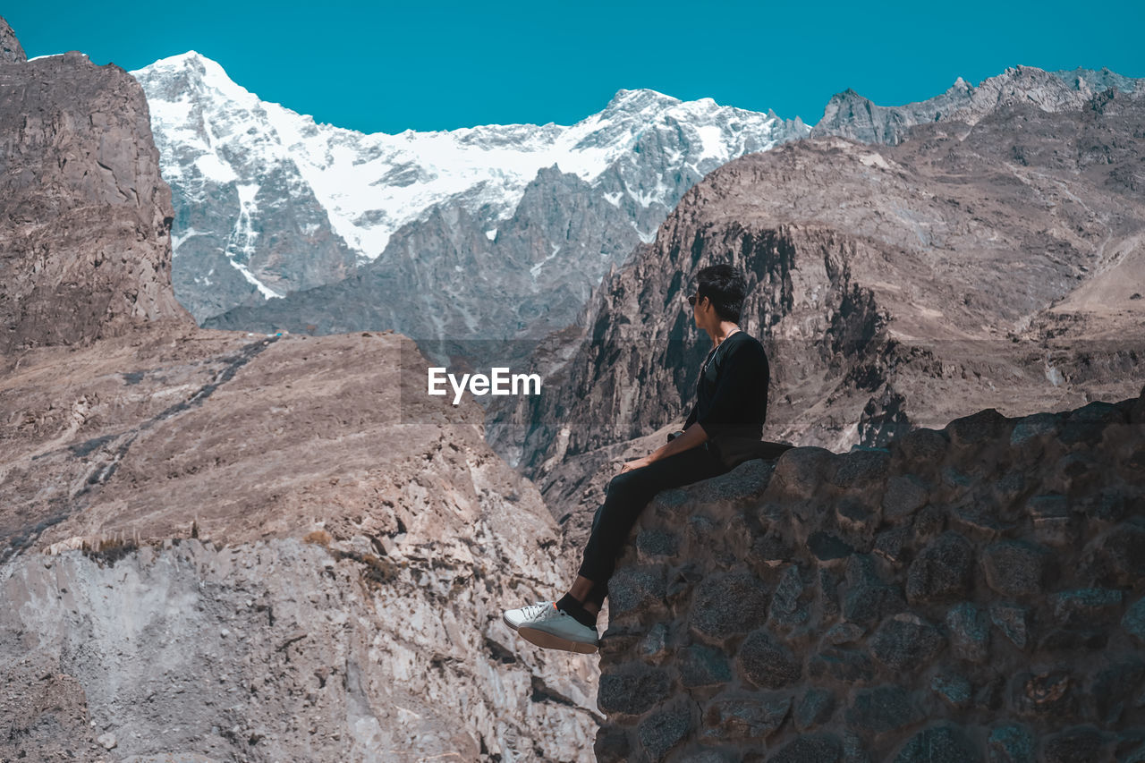 Man while sitting on mountain