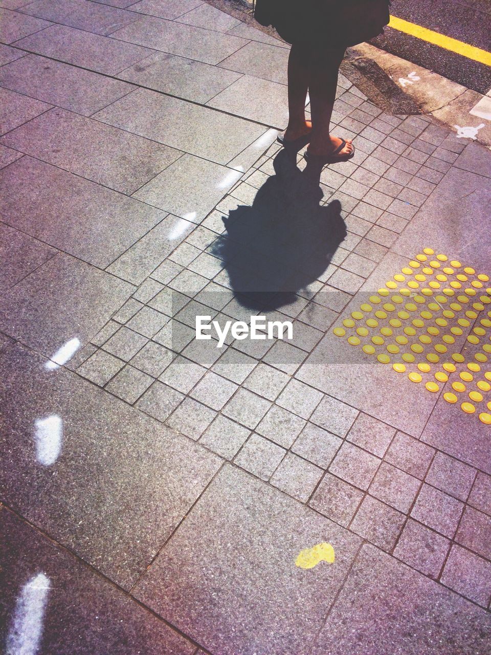 Shadow of woman standing on street