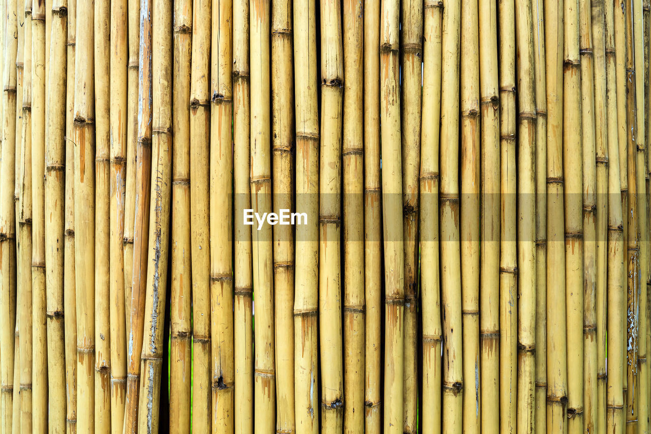 Old brown tone bamboo simple wall or bamboo fence texture background for  design vintage tone. 