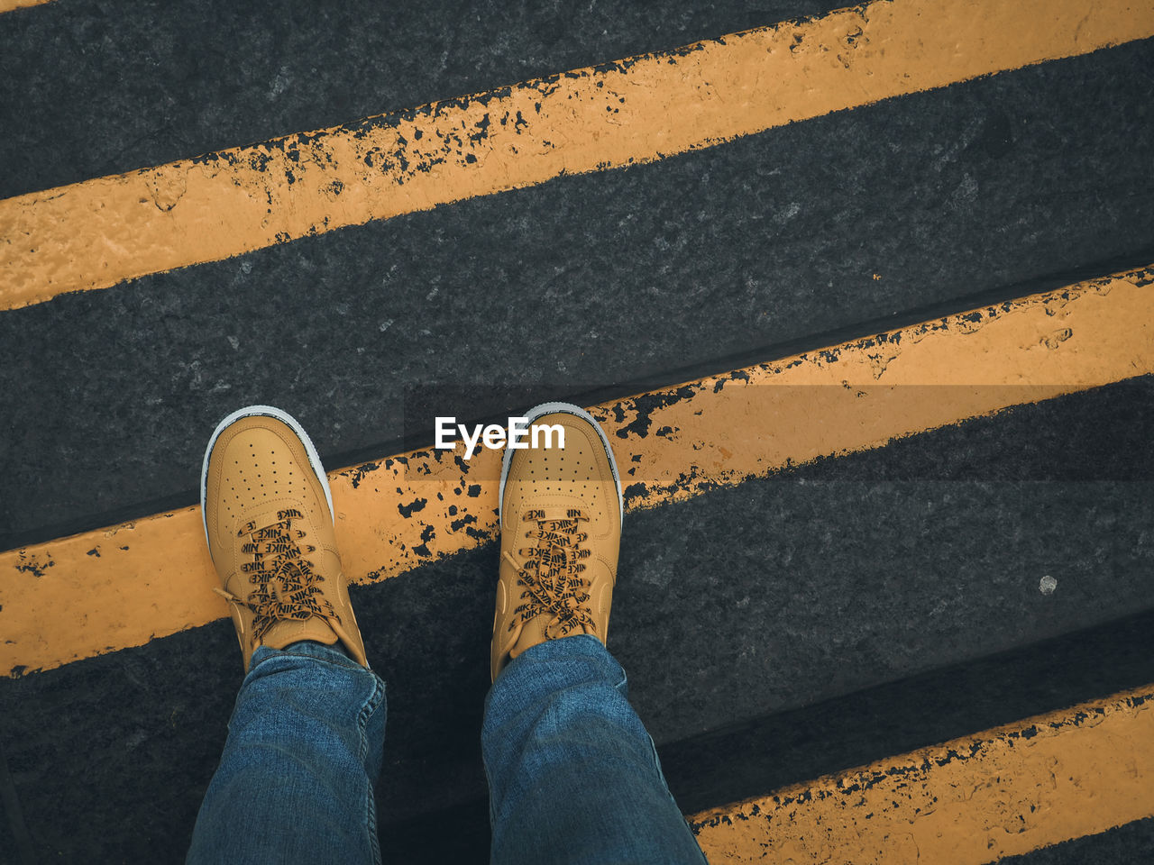 LOW SECTION OF WOMAN STANDING ON ROAD