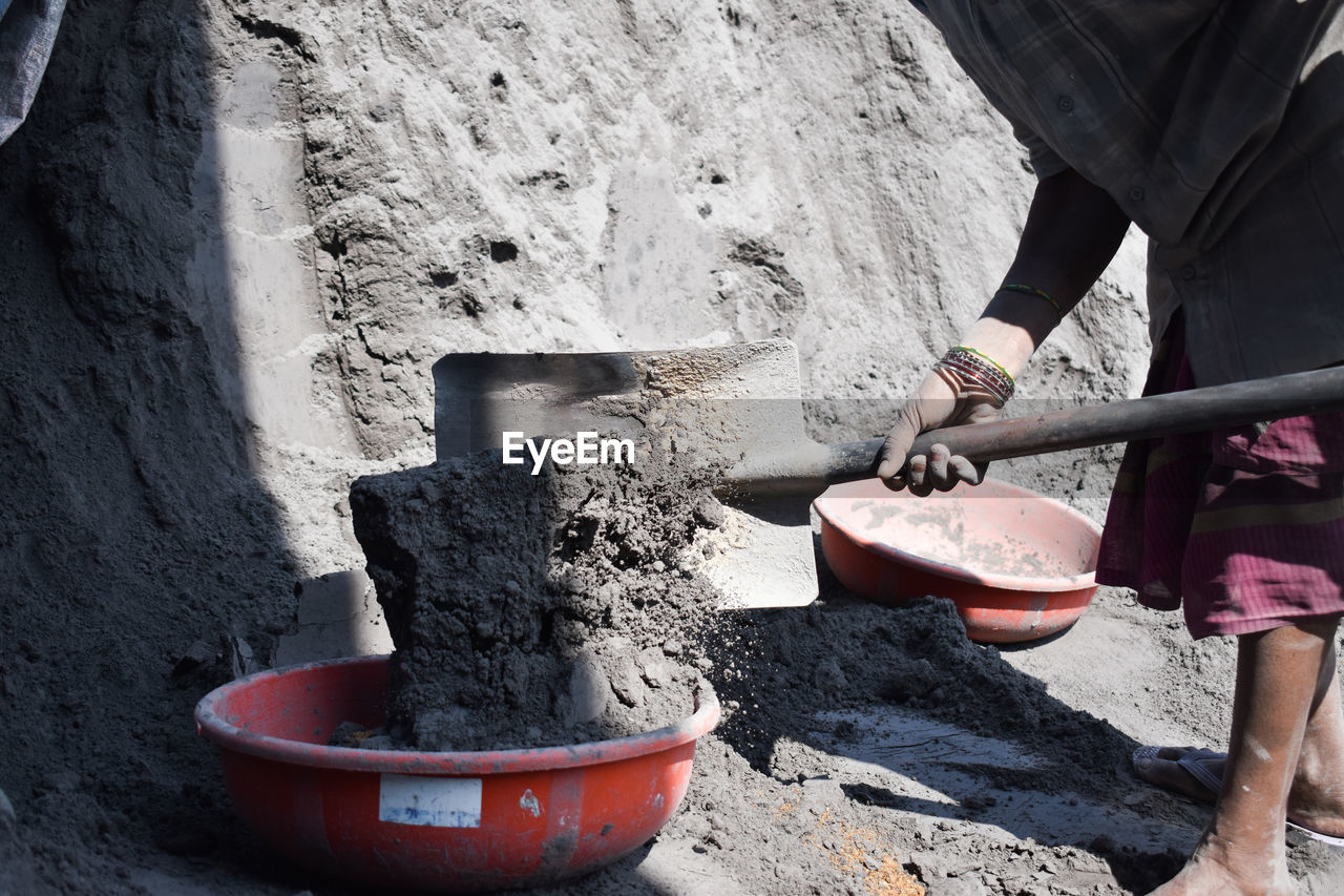 MIDSECTION OF MAN WORKING IN WATER