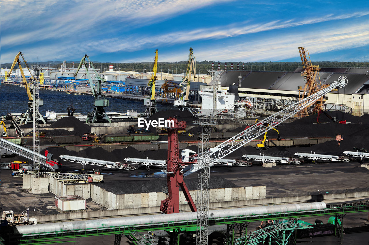 boats moored at harbor against sky