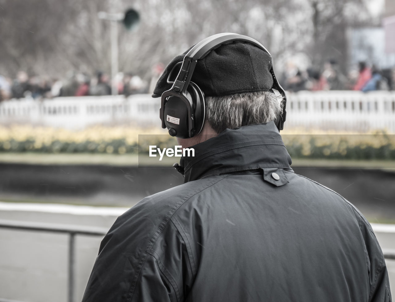 Rear view of man listening music in city