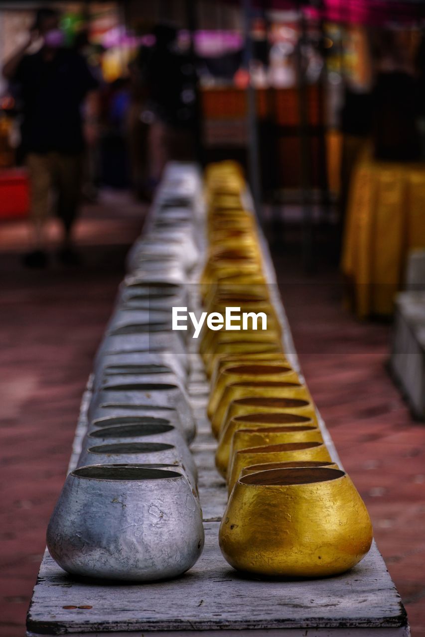 footwear, yellow, focus on foreground, in a row, architecture, city, street, no people
