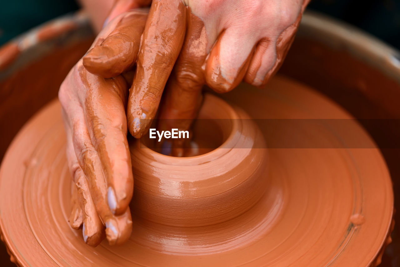 Hands of a potter. potter making ceramic pot on the pottery wheel