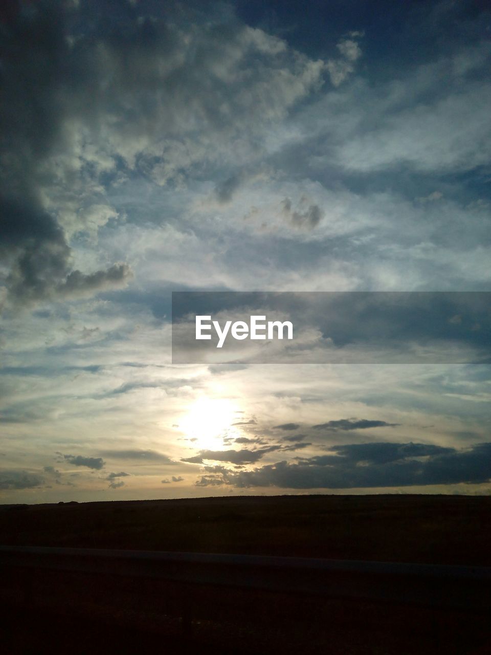 SCENIC VIEW OF LANDSCAPE AGAINST CLOUDY SKY DURING SUNSET