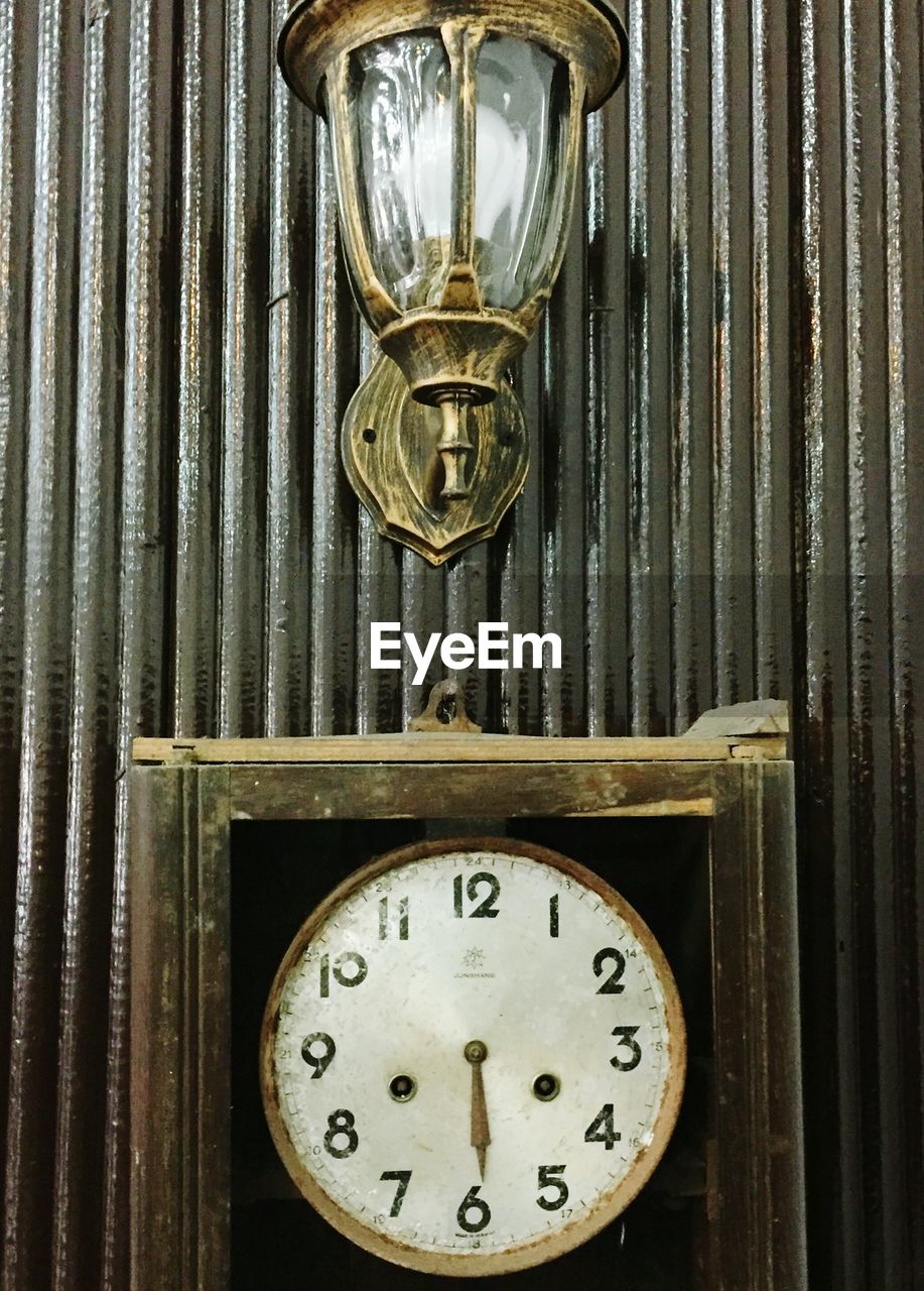 CLOSE-UP OF CLOCK ON WALL