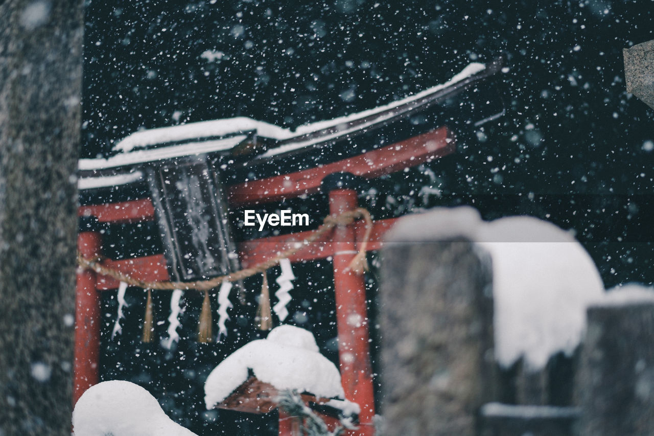 View of torii gate during snowfall