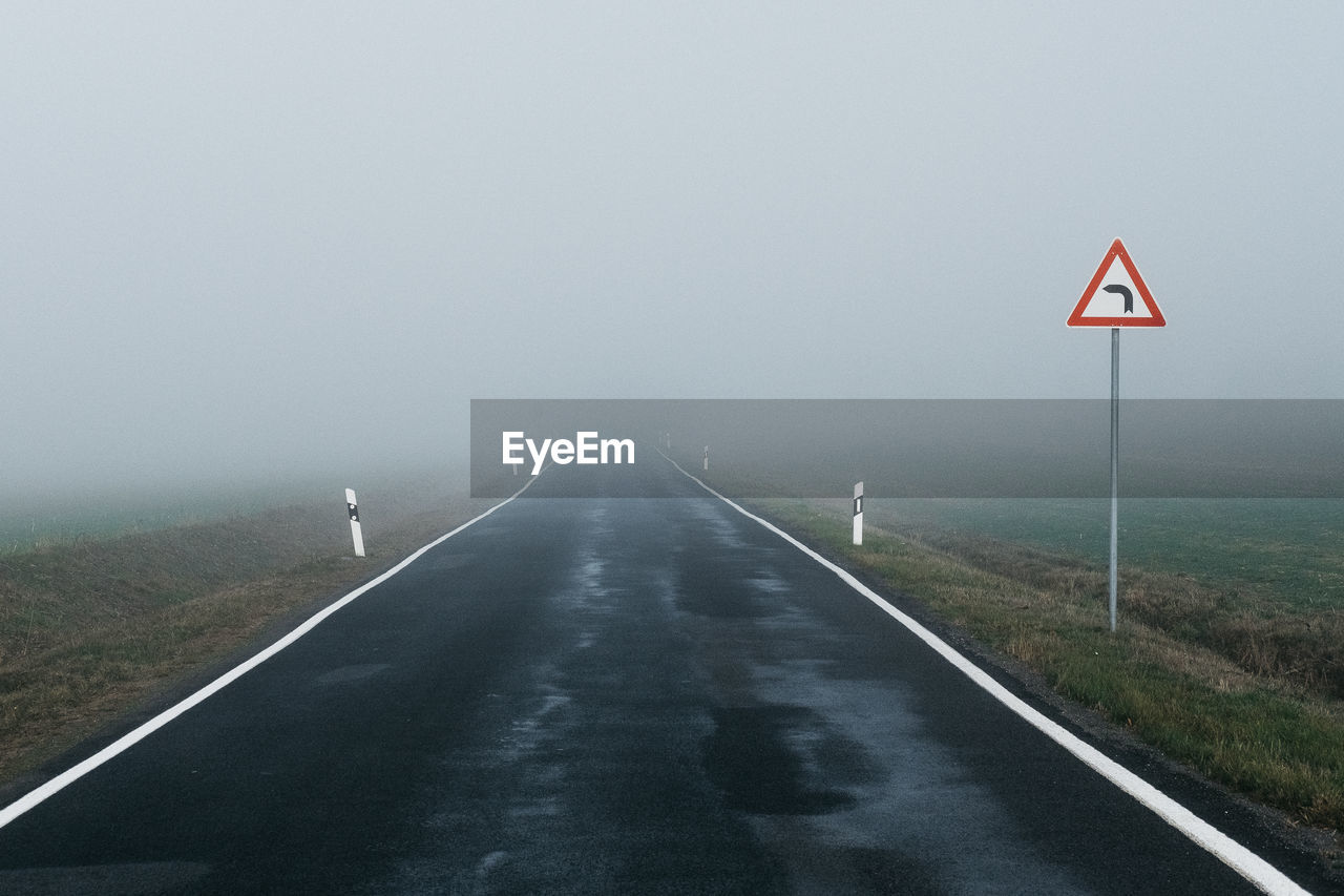 Empty road against sky during foggy weather