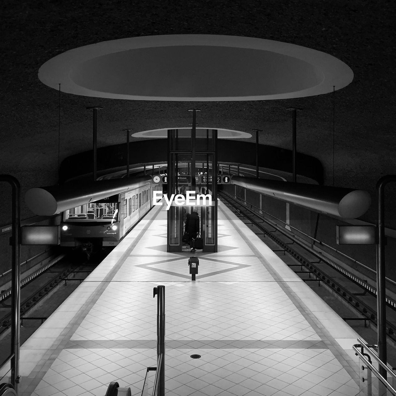 TRAIN ON RAILROAD STATION PLATFORM