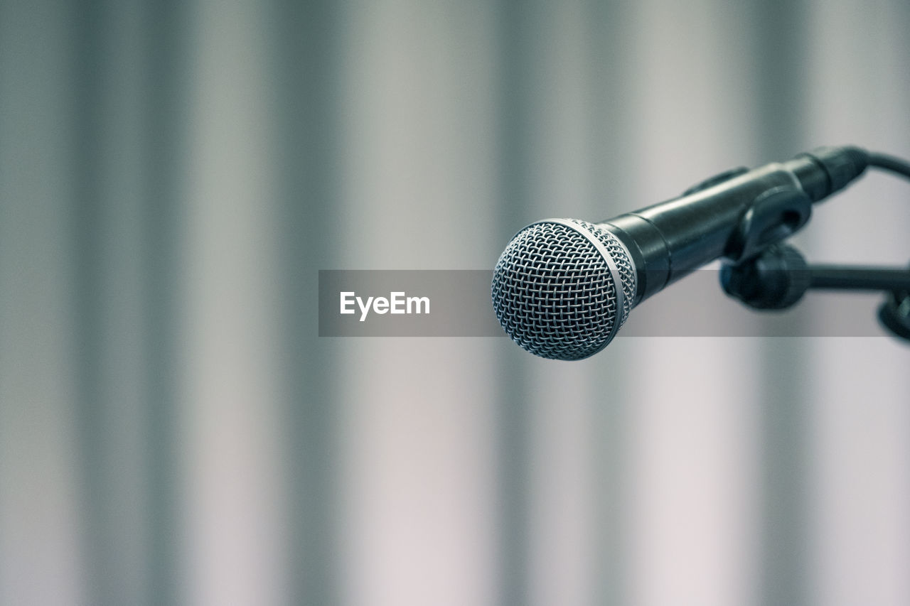 Close-up of microphone against wall